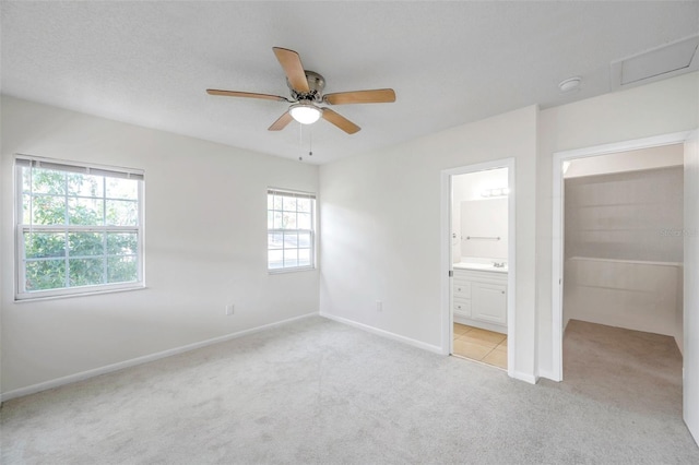 8521 N 29th St, Tampa, FL 33604 - unfurnished bedroom featuring carpet, baseboards, ensuite bath, and ceiling fan