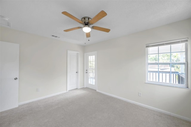 8521 N 29th St, Tampa, FL 33604 - unfurnished room featuring plenty of natural light, a ceiling fan, carpet, and baseboards