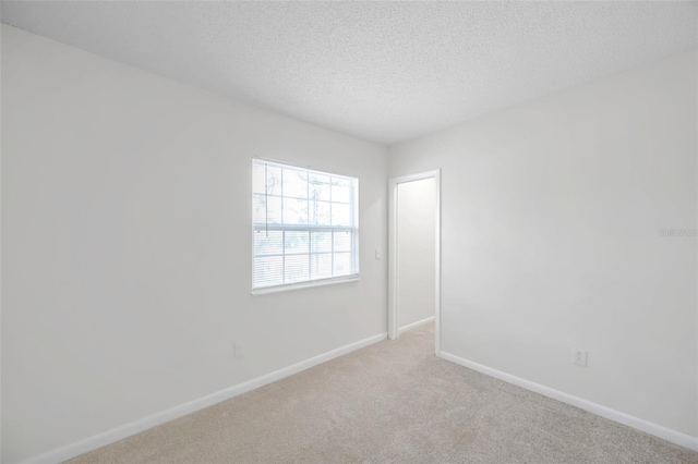 8521 N 29th St, Tampa, FL 33604 - carpeted spare room featuring baseboards and a textured ceiling