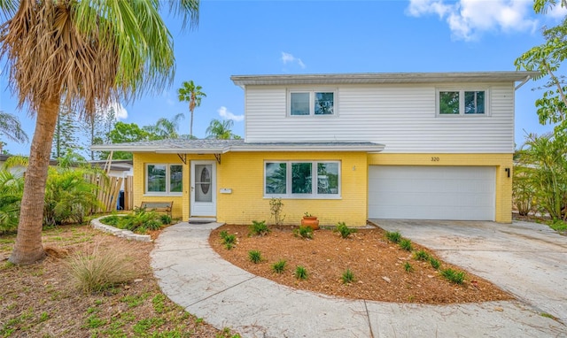 320 Tallahassee Dr NE, Saint Petersburg, FL 33702 - view of front of home with an attached garage, brick siding, and driveway