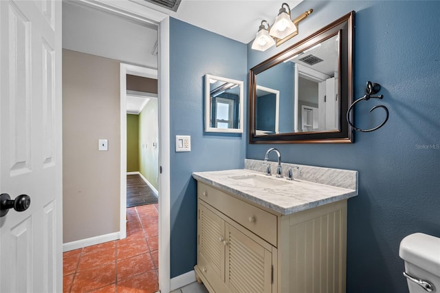 320 Tallahassee Dr NE, Saint Petersburg, FL 33702 - bathroom featuring vanity, toilet, tile patterned flooring, and baseboards