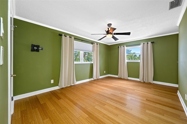 320 Tallahassee Dr NE, Saint Petersburg, FL 33702 - empty room featuring baseboards, ceiling fan, plenty of natural light, light wood finished floors, and crown molding