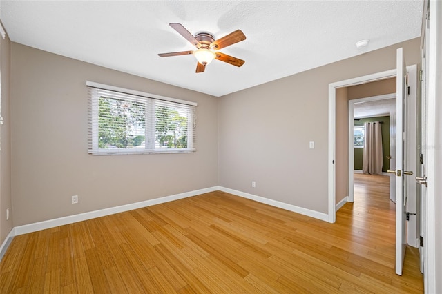 320 Tallahassee Dr NE, Saint Petersburg, FL 33702 - empty room featuring ceiling fan, light wood-style flooring, baseboards, and a smoke detector