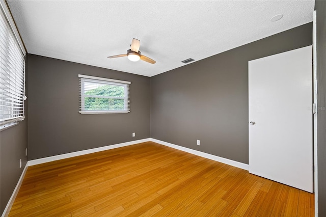 320 Tallahassee Dr NE, Saint Petersburg, FL 33702 - empty room with a ceiling fan, light wood-style floors, baseboards, and a textured ceiling