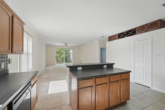 442 Graystone Blvd, Davenport, FL 33837 - kitchen featuring light tile patterned flooring, dark countertops, dishwasher, a ceiling fan, and a center island