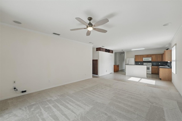 442 Graystone Blvd, Davenport, FL 33837 - unfurnished living room with ornamental molding, ceiling fan, light carpet, a sink, and baseboards