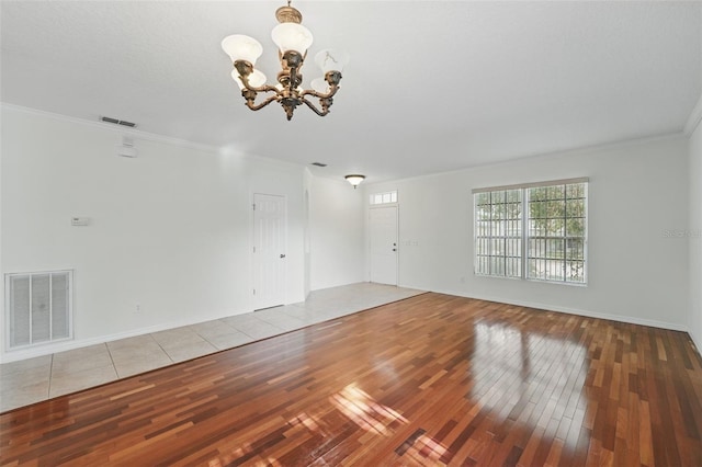 442 Graystone Blvd, Davenport, FL 33837 - unfurnished living room featuring a chandelier, hardwood / wood-style flooring, ornamental molding, and baseboards
