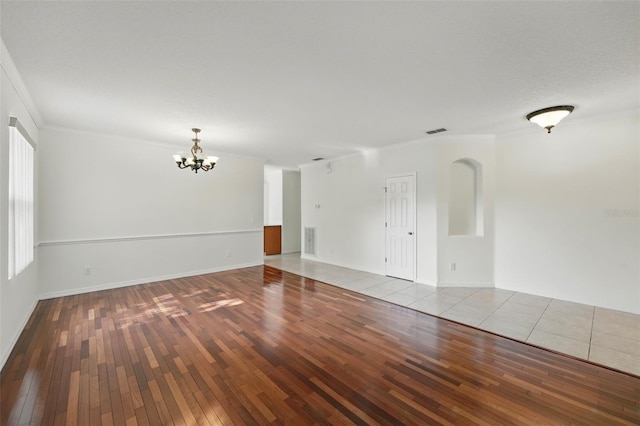 442 Graystone Blvd, Davenport, FL 33837 - empty room with hardwood / wood-style floors, a chandelier, ornamental molding, and baseboards