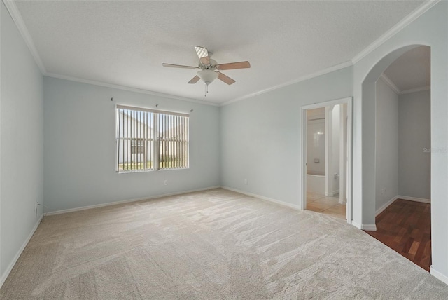 442 Graystone Blvd, Davenport, FL 33837 - carpeted spare room featuring arched walkways, a ceiling fan, crown molding, and baseboards