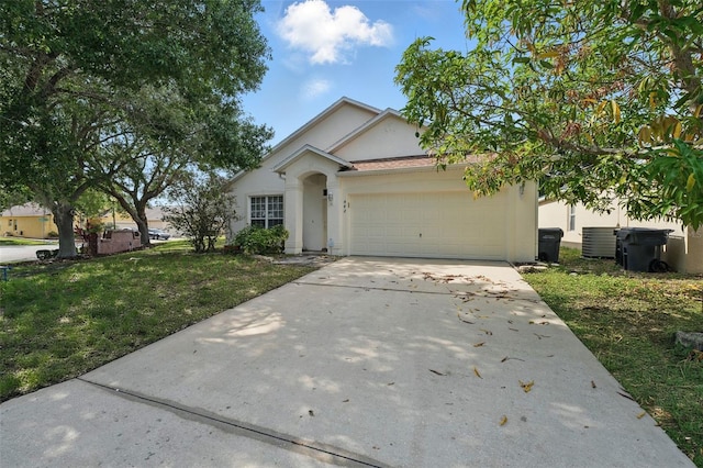 442 Graystone Blvd, Davenport, FL 33837 - ranch-style home featuring stucco siding, concrete driveway, an attached garage, a front lawn, and central AC