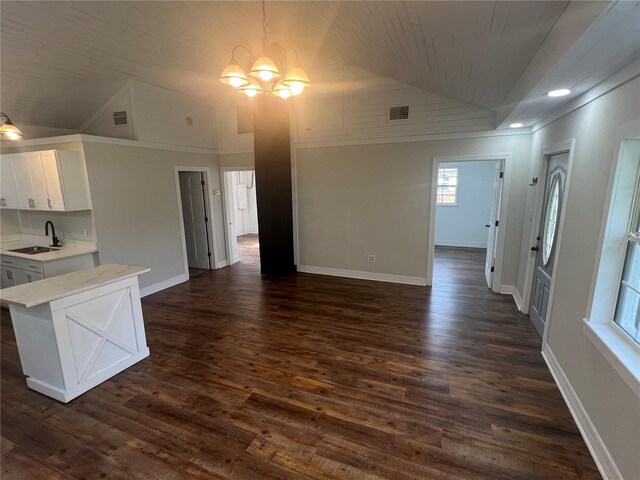 18127 US Highway 41, Spring Hill, FL 34610 - kitchen featuring vaulted ceiling, a sink, light countertops, open floor plan, and white cabinets