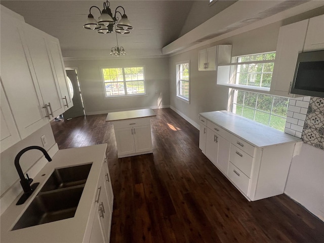 18127 US Highway 41, Spring Hill, FL 34610 - kitchen featuring a sink, a chandelier, dark wood-style flooring, white cabinets, and light countertops