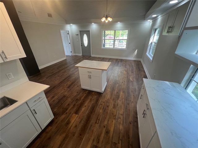 18127 US Highway 41, Spring Hill, FL 34610 - kitchen featuring crown molding, open floor plan, light countertops, white cabinets, and a chandelier