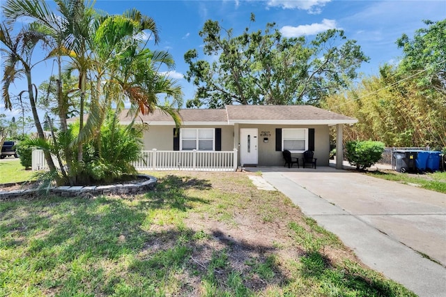 206 4th Ave NW, Ruskin, FL 33570 - ranch-style home featuring covered porch, stucco siding, and driveway