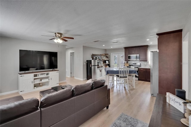 206 4th Ave NW, Ruskin, FL 33570 - living room featuring a ceiling fan, light wood-type flooring, baseboards, a textured ceiling, and recessed lighting