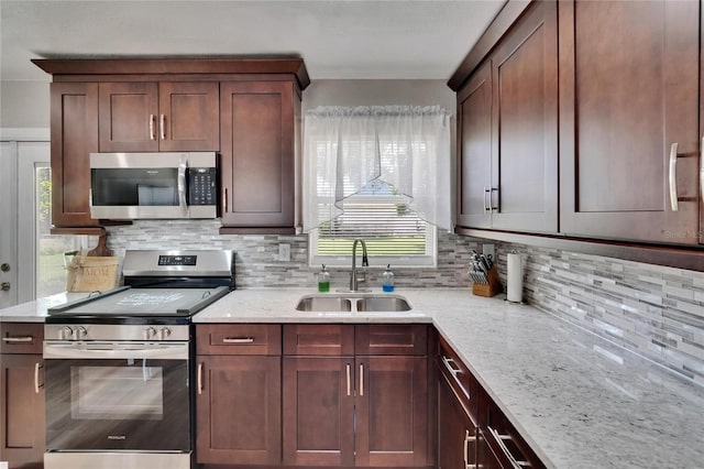 206 4th Ave NW, Ruskin, FL 33570 - kitchen featuring stainless steel appliances, a sink, plenty of natural light, and tasteful backsplash