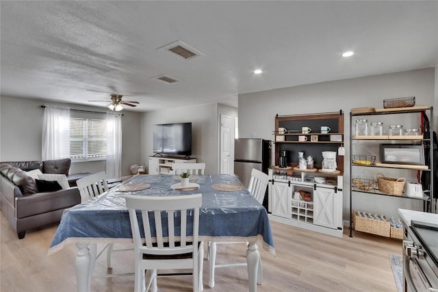 206 4th Ave NW, Ruskin, FL 33570 - dining room with light wood-type flooring, ceiling fan, and recessed lighting