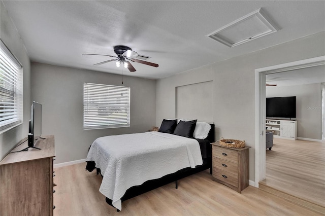 206 4th Ave NW, Ruskin, FL 33570 - bedroom with light wood finished floors, attic access, baseboards, and ceiling fan