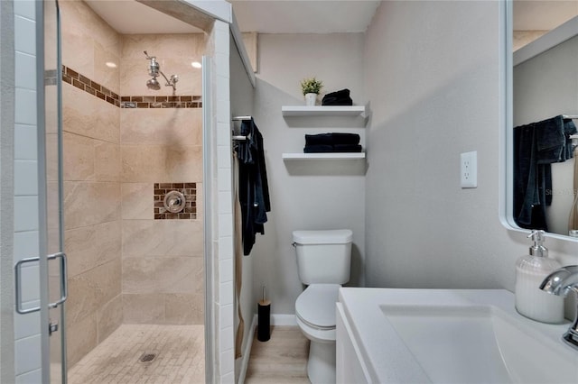 206 4th Ave NW, Ruskin, FL 33570 - bathroom featuring toilet, a stall shower, vanity, and wood finished floors