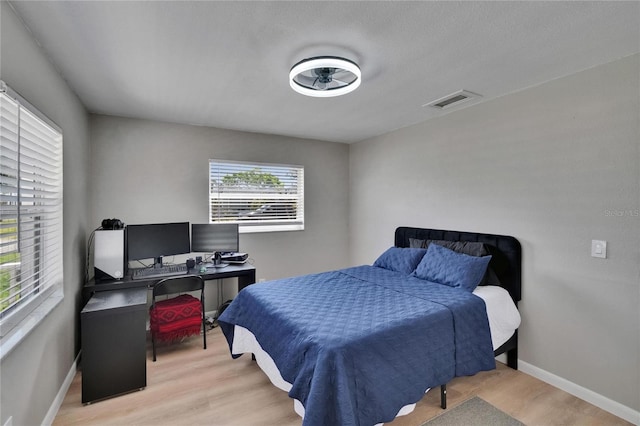 206 4th Ave NW, Ruskin, FL 33570 - bedroom featuring light wood finished floors, baseboards, and a desk