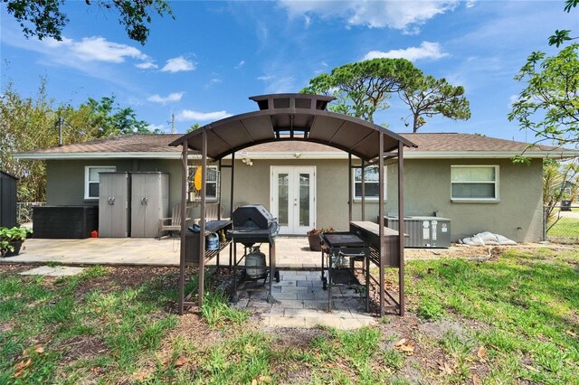 206 4th Ave NW, Ruskin, FL 33570 - rear view of property featuring french doors, stucco siding, cooling unit, and a patio area