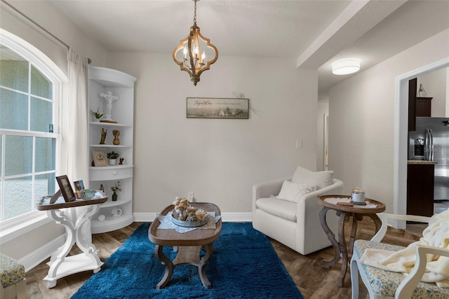 10197 Meadow Wren Ave, Weeki Wachee, FL 34613 - living area with a chandelier, wood finished floors, and baseboards