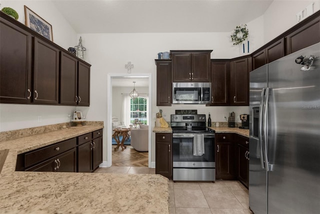 10197 Meadow Wren Ave, Weeki Wachee, FL 34613 - kitchen featuring stainless steel appliances and dark brown cabinetry