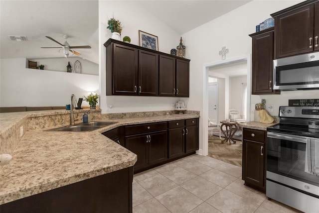 10197 Meadow Wren Ave, Weeki Wachee, FL 34613 - kitchen with appliances with stainless steel finishes, a sink, lofted ceiling, a ceiling fan, and dark brown cabinetry