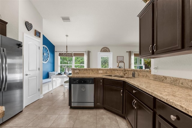 10197 Meadow Wren Ave, Weeki Wachee, FL 34613 - kitchen with appliances with stainless steel finishes, a sink, dark brown cabinets, and light tile patterned floors
