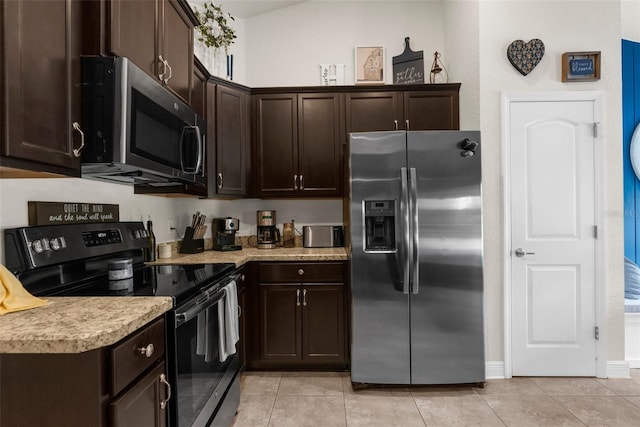 10197 Meadow Wren Ave, Weeki Wachee, FL 34613 - kitchen with stainless steel appliances, dark brown cabinets, light countertops, and light tile patterned floors