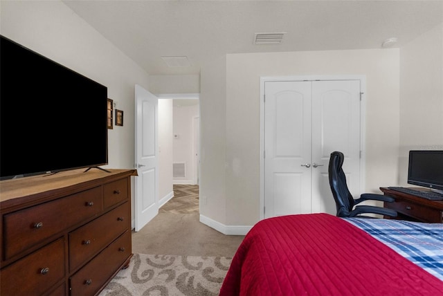 10197 Meadow Wren Ave, Weeki Wachee, FL 34613 - bedroom featuring light carpet, a closet, and baseboards