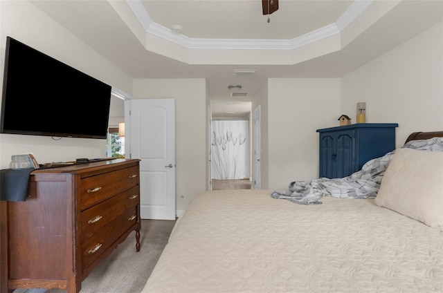 10197 Meadow Wren Ave, Weeki Wachee, FL 34613 - carpeted bedroom with a tray ceiling, crown molding, and ceiling fan