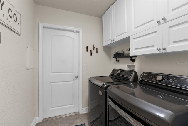 10197 Meadow Wren Ave, Weeki Wachee, FL 34613 - washroom featuring cabinet space, washer and clothes dryer, light tile patterned floors, and baseboards