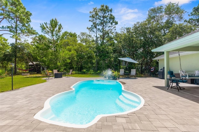 10197 Meadow Wren Ave, Weeki Wachee, FL 34613 - swimming pool with a patio and view of wooded area