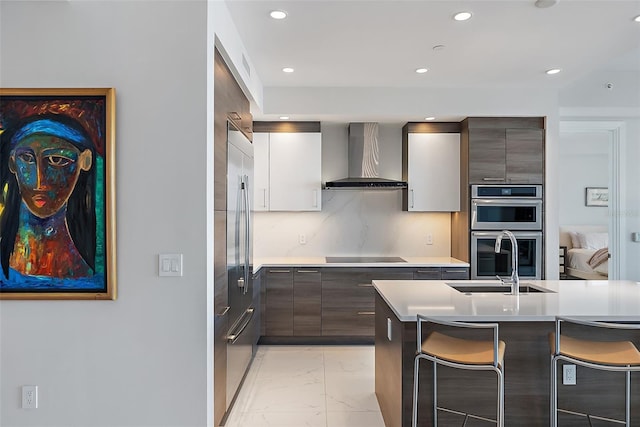 100 1st Ave N Unit 2703, Saint Petersburg, FL 33701 - kitchen with wall chimney range hood, light marble finish floors, a sink, a kitchen bar, and modern cabinets