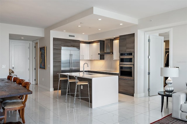 100 1st Ave N Unit 2703, Saint Petersburg, FL 33701 - kitchen with wall chimney exhaust hood, modern cabinets, a breakfast bar, stainless steel appliances, and recessed lighting
