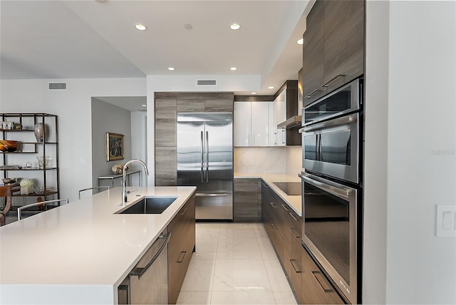 100 1st Ave N Unit 2703, Saint Petersburg, FL 33701 - kitchen featuring stainless steel appliances, modern cabinets, a sink, light marble finish flooring, and recessed lighting