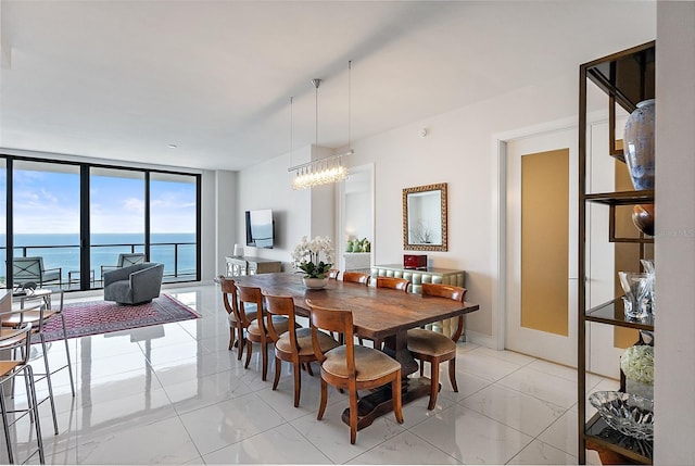 100 1st Ave N Unit 2703, Saint Petersburg, FL 33701 - dining area with light marble finish floors, floor to ceiling windows, a chandelier, and a water view