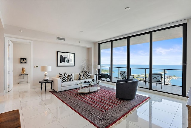 100 1st Ave N Unit 2703, Saint Petersburg, FL 33701 - living area with expansive windows, a water view, light marble finish floors, and baseboards