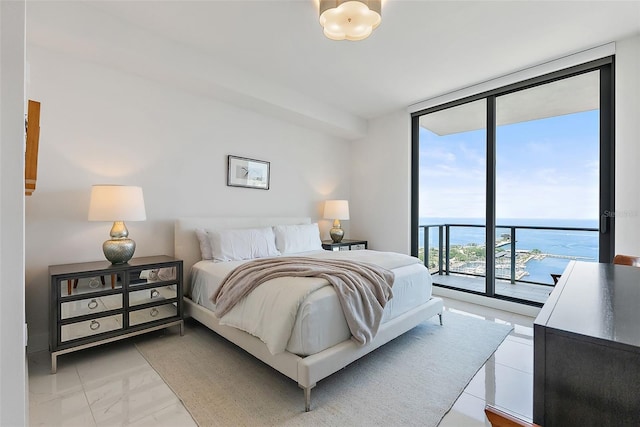 100 1st Ave N Unit 2703, Saint Petersburg, FL 33701 - bedroom featuring expansive windows, access to exterior, light marble finish flooring, and a water view
