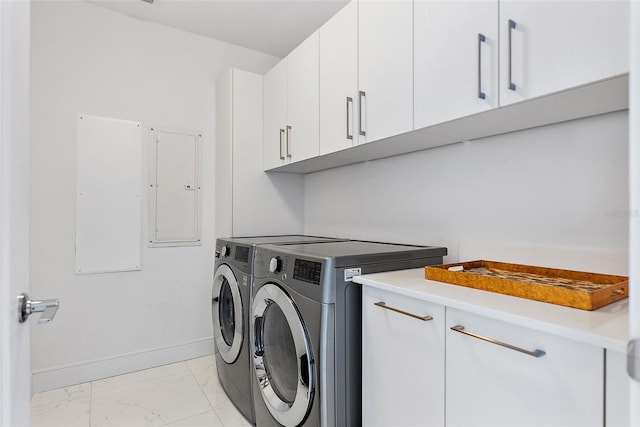 100 1st Ave N Unit 2703, Saint Petersburg, FL 33701 - laundry area featuring washing machine and dryer, light marble finish flooring, electric panel, cabinet space, and baseboards