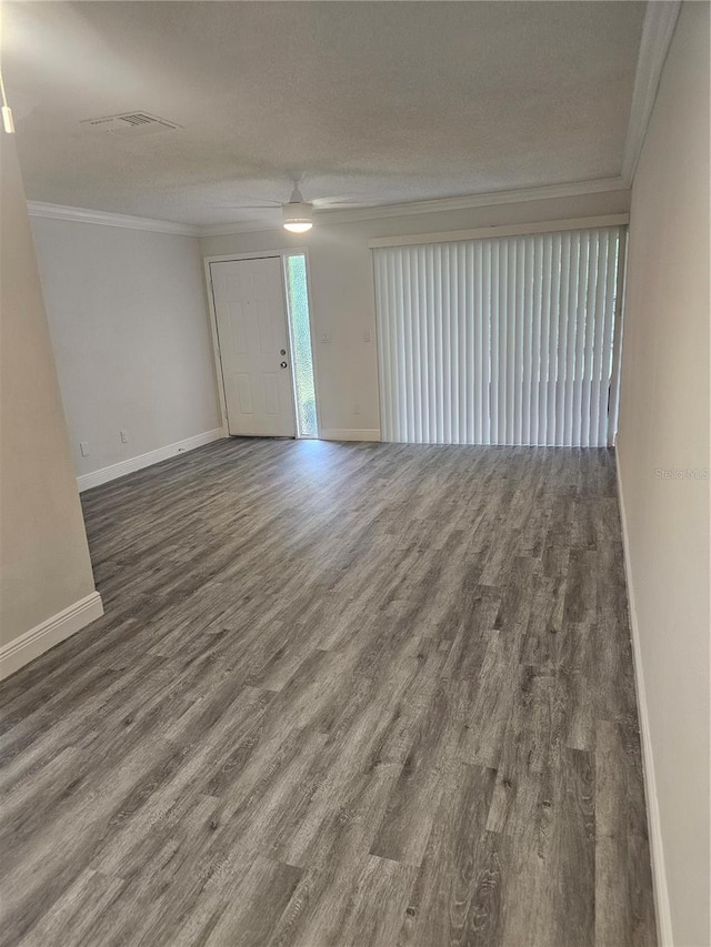 1107 Queen Anne Dr Unit C, Palm Harbor, FL 34684 - spare room featuring ornamental molding, wood finished floors, baseboards, and ceiling fan
