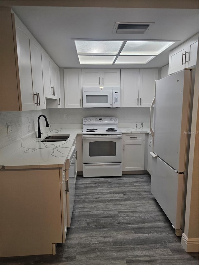 1107 Queen Anne Dr Unit C, Palm Harbor, FL 34684 - kitchen with white appliances, a sink, dark wood finished floors, and white cabinets