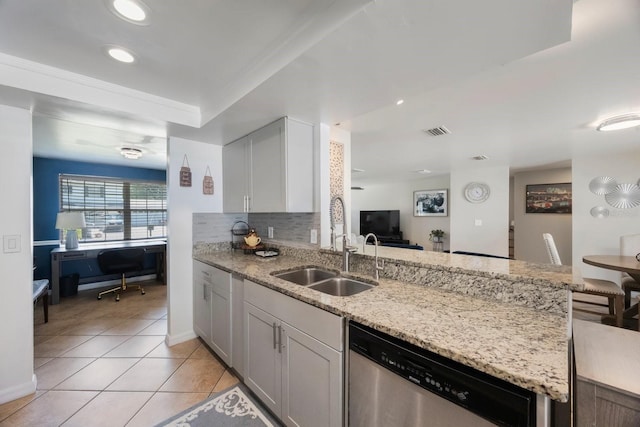 1706 Sloop Pl, Brandon, FL 33511 - kitchen with stainless steel dishwasher, a sink, a peninsula, light tile patterned floors, and light stone counters