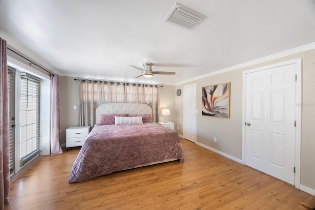1706 Sloop Pl, Brandon, FL 33511 - bedroom with multiple windows, ornamental molding, light wood-style flooring, access to exterior, and baseboards