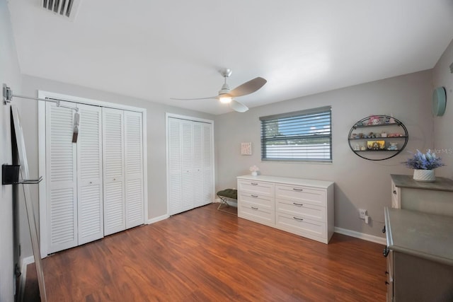 1706 Sloop Pl, Brandon, FL 33511 - bedroom featuring two closets, baseboards, dark wood-style flooring, and ceiling fan
