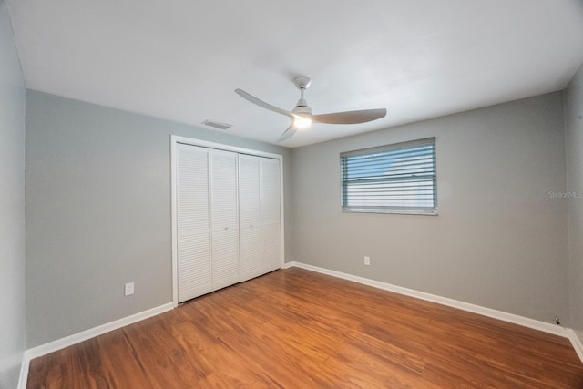1706 Sloop Pl, Brandon, FL 33511 - unfurnished bedroom featuring a closet, baseboards, wood finished floors, and ceiling fan