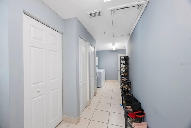 1706 Sloop Pl, Brandon, FL 33511 - hall featuring washer and clothes dryer, light tile patterned flooring, attic access, and baseboards