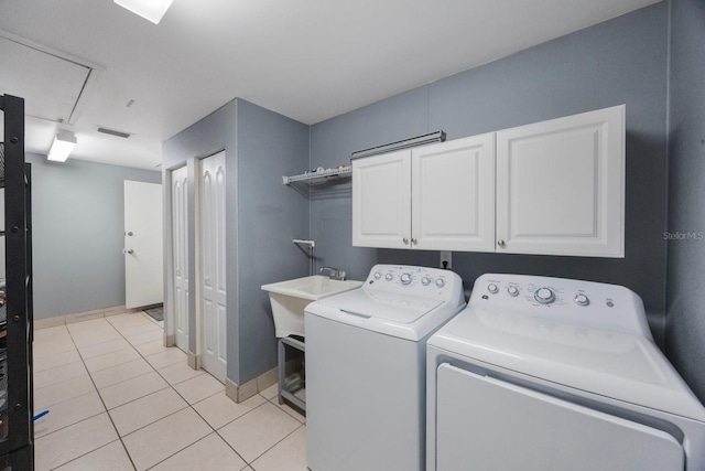 1706 Sloop Pl, Brandon, FL 33511 - laundry room featuring cabinet space, washing machine and clothes dryer, and light tile patterned floors