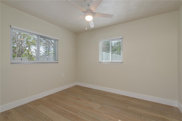 2010 Bayview Pl, Indian Rocks Beach, FL 33785 - spare room with healthy amount of natural light, light wood-type flooring, baseboards, and a ceiling fan